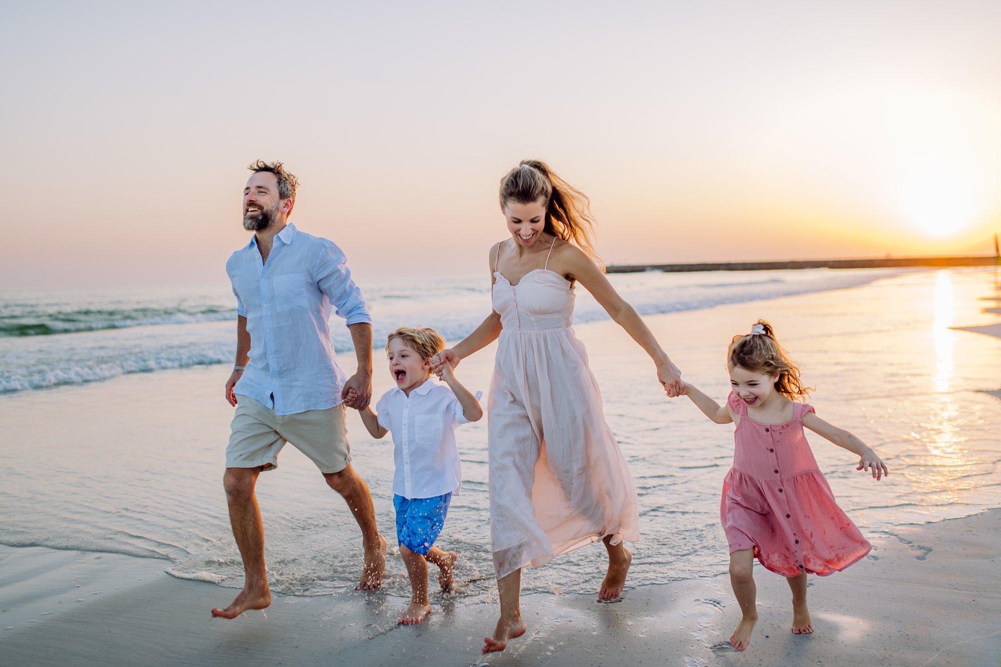 Family on the beach at sunset